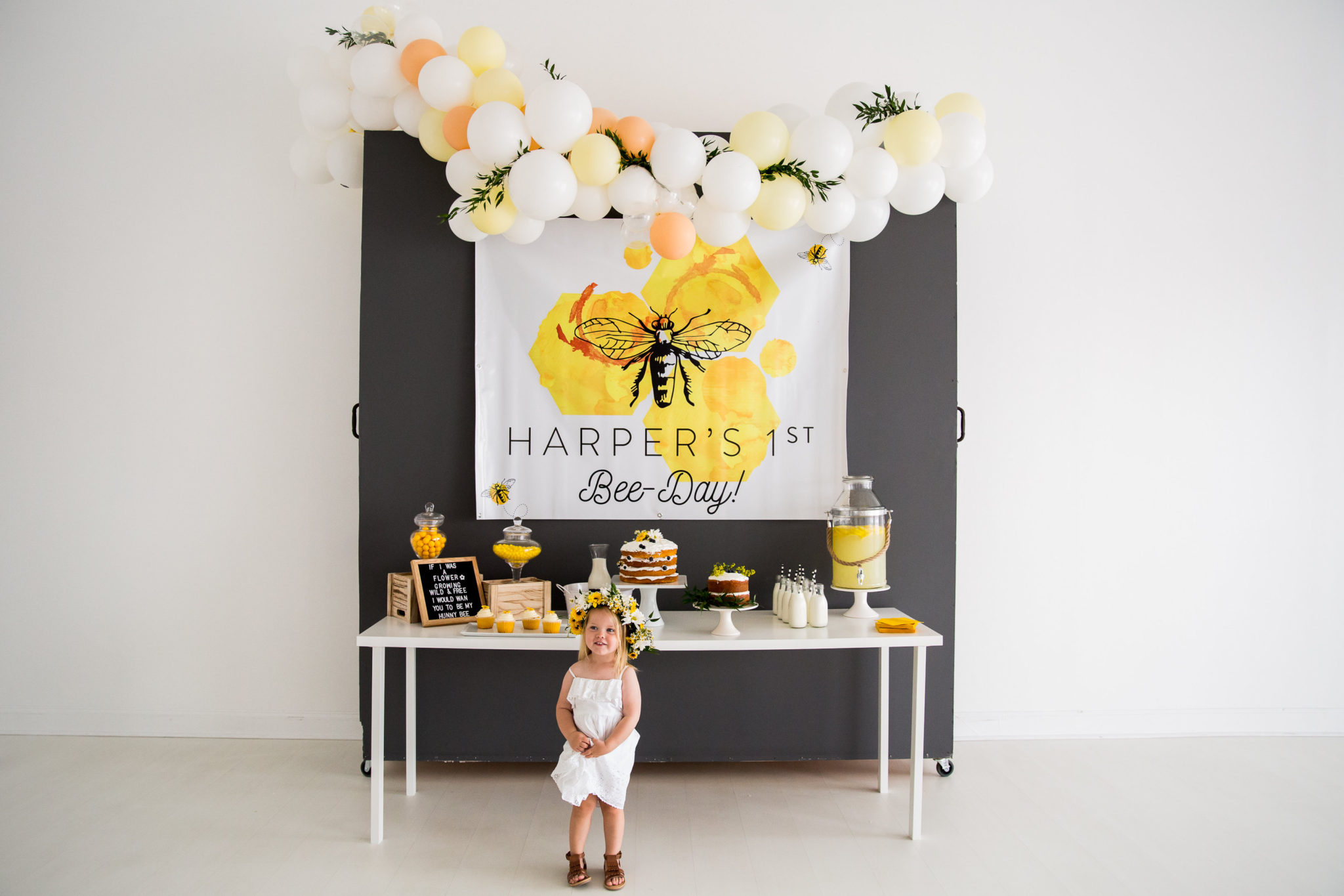 bee themed 1st birthday display with little girl