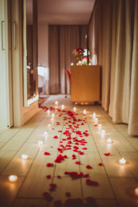 red rose petals and tealights in hall